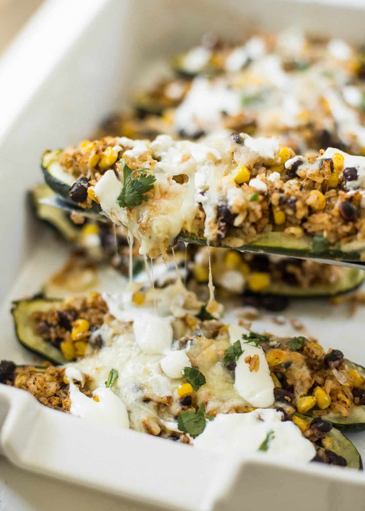 stuffed zucchini boats on a white tray