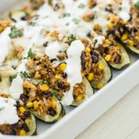 stuffed zucchini in a white baking dish