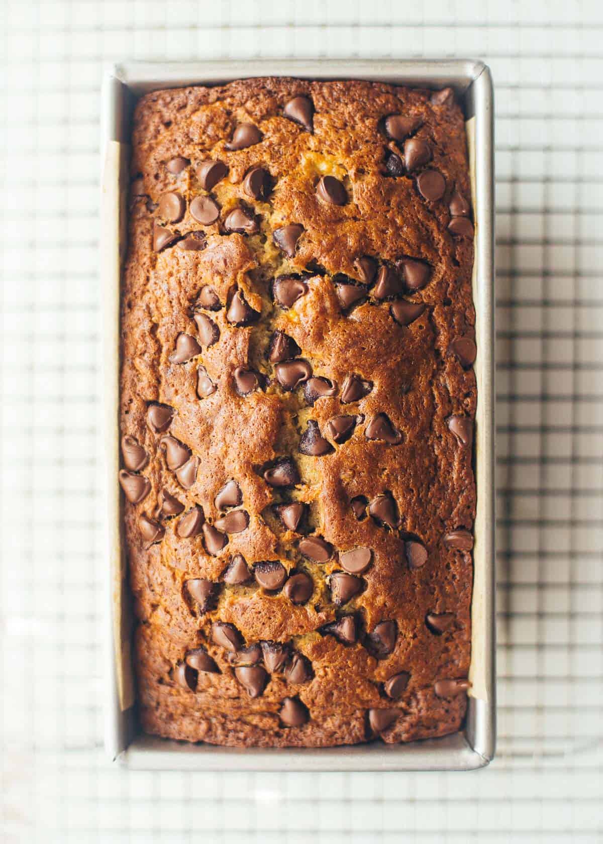 banana bread in a pan with chocolate chips