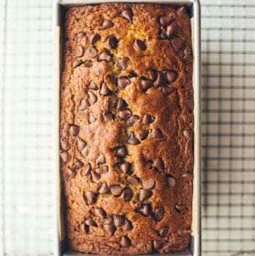 banana bread in a pan with chocolate chips