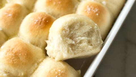 buttery dinner rolls in a rectangular white baking dish