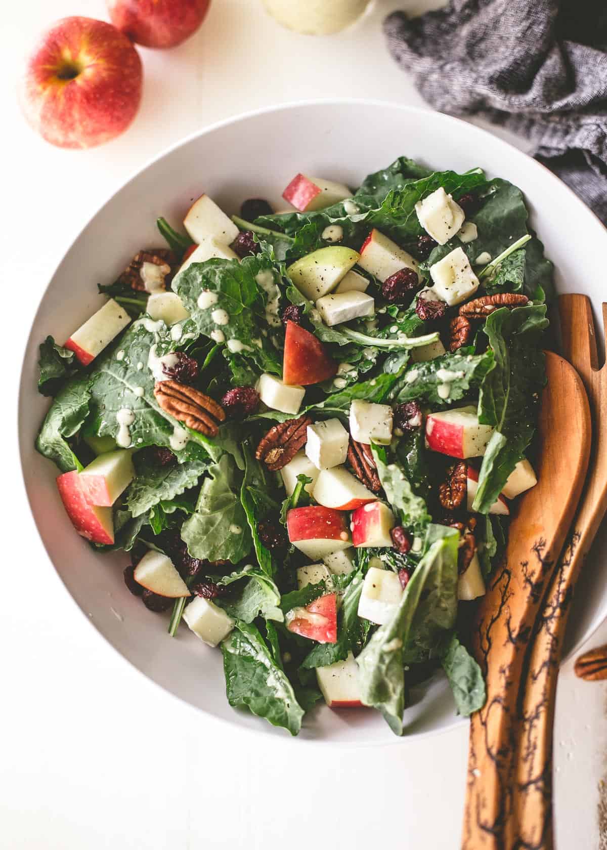 overhead image of apple, brie and pecan salad in a white bowl