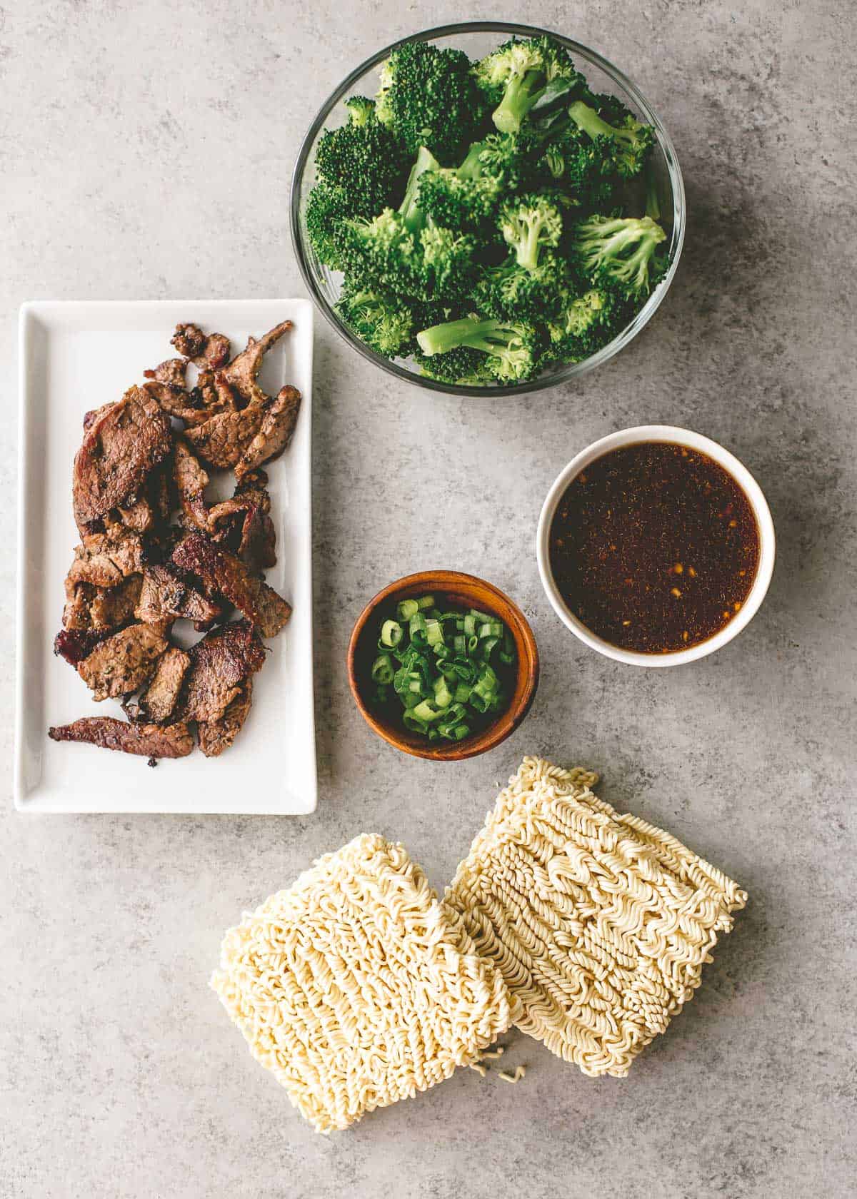 ingredients for beef and broccoli stir fry on a grey counter