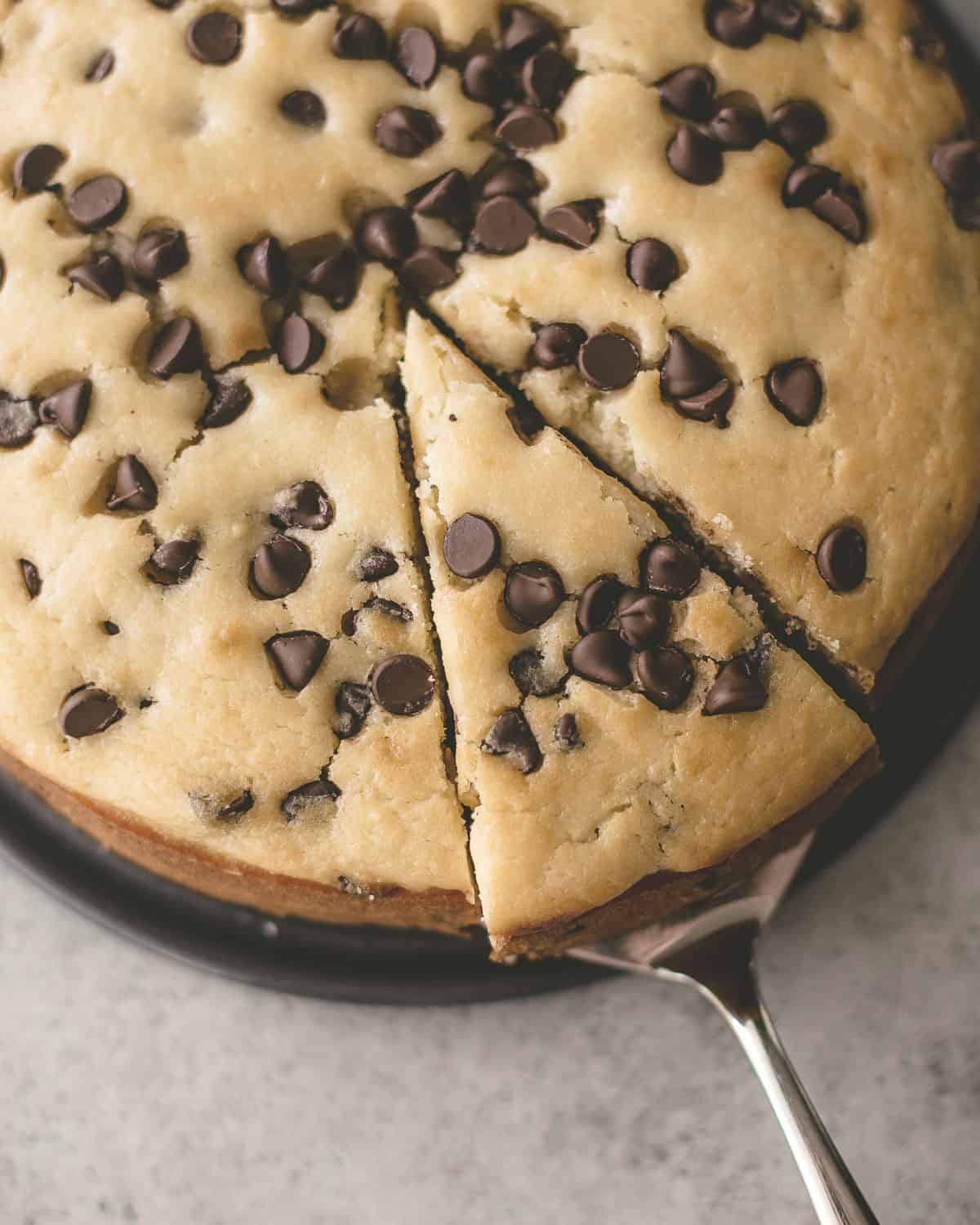 overhead image of a chocolate chip ricotta cake cut into slices