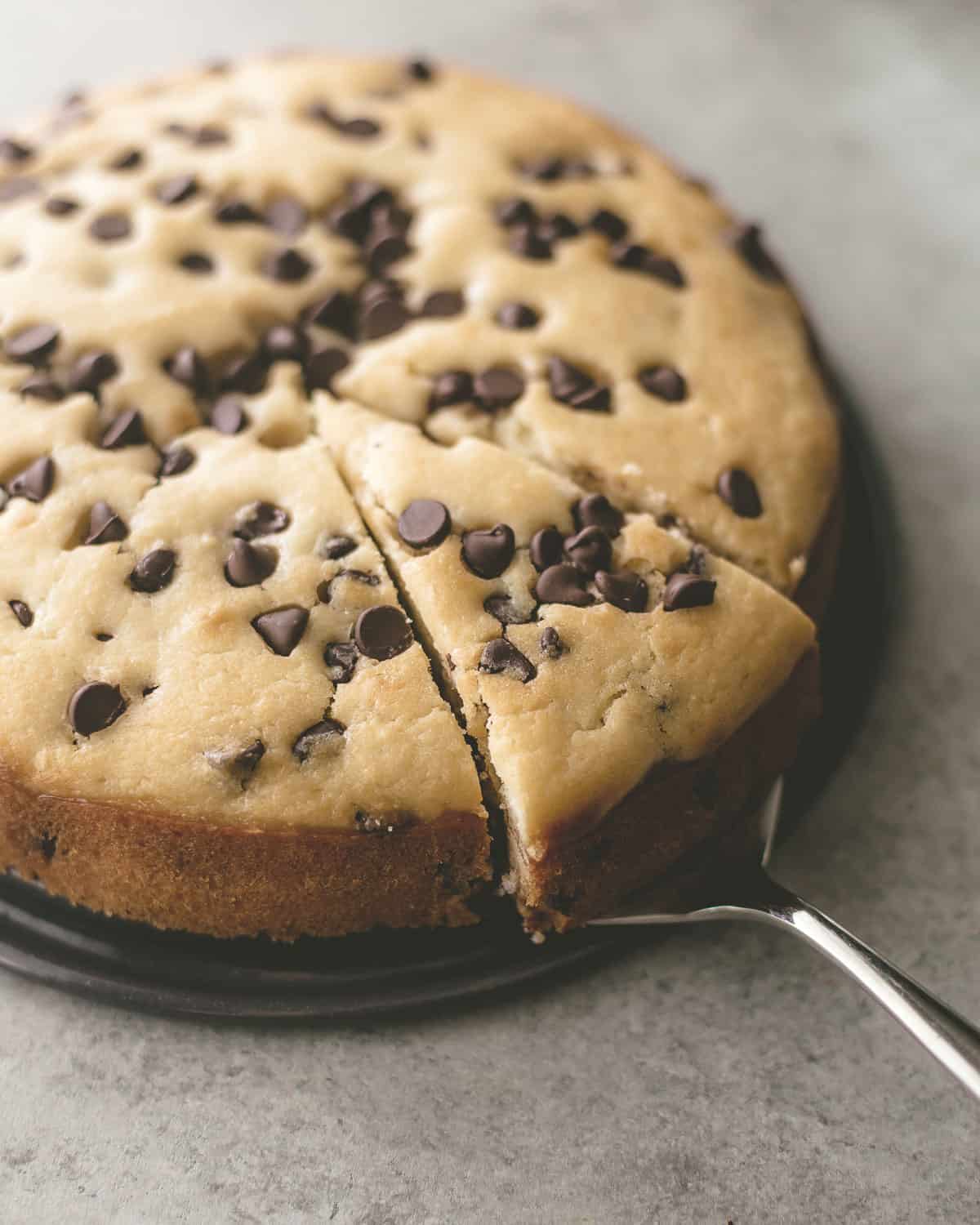 removing a slice of chocolate chip ricotta cake