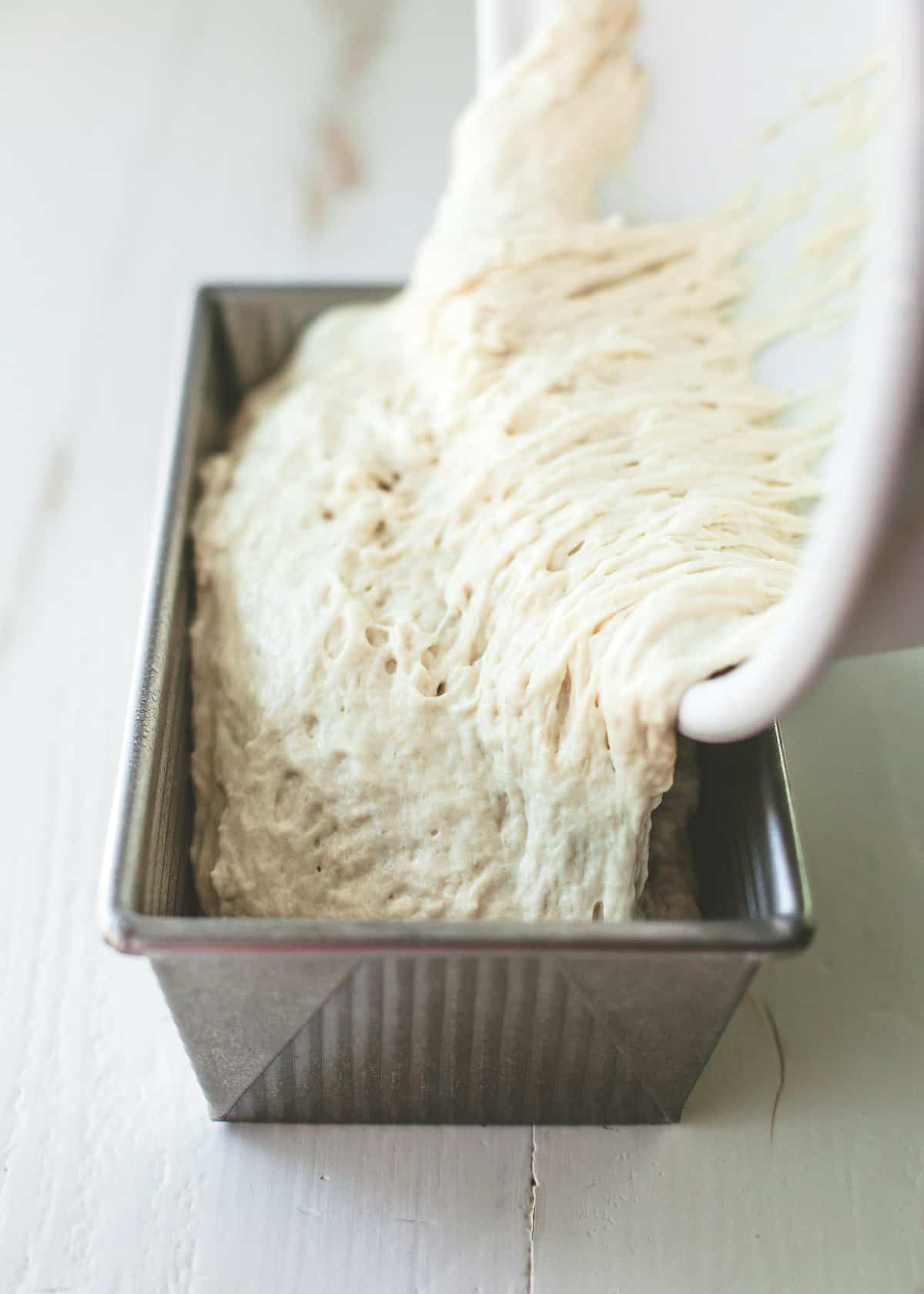 pouring dough into loaf pan