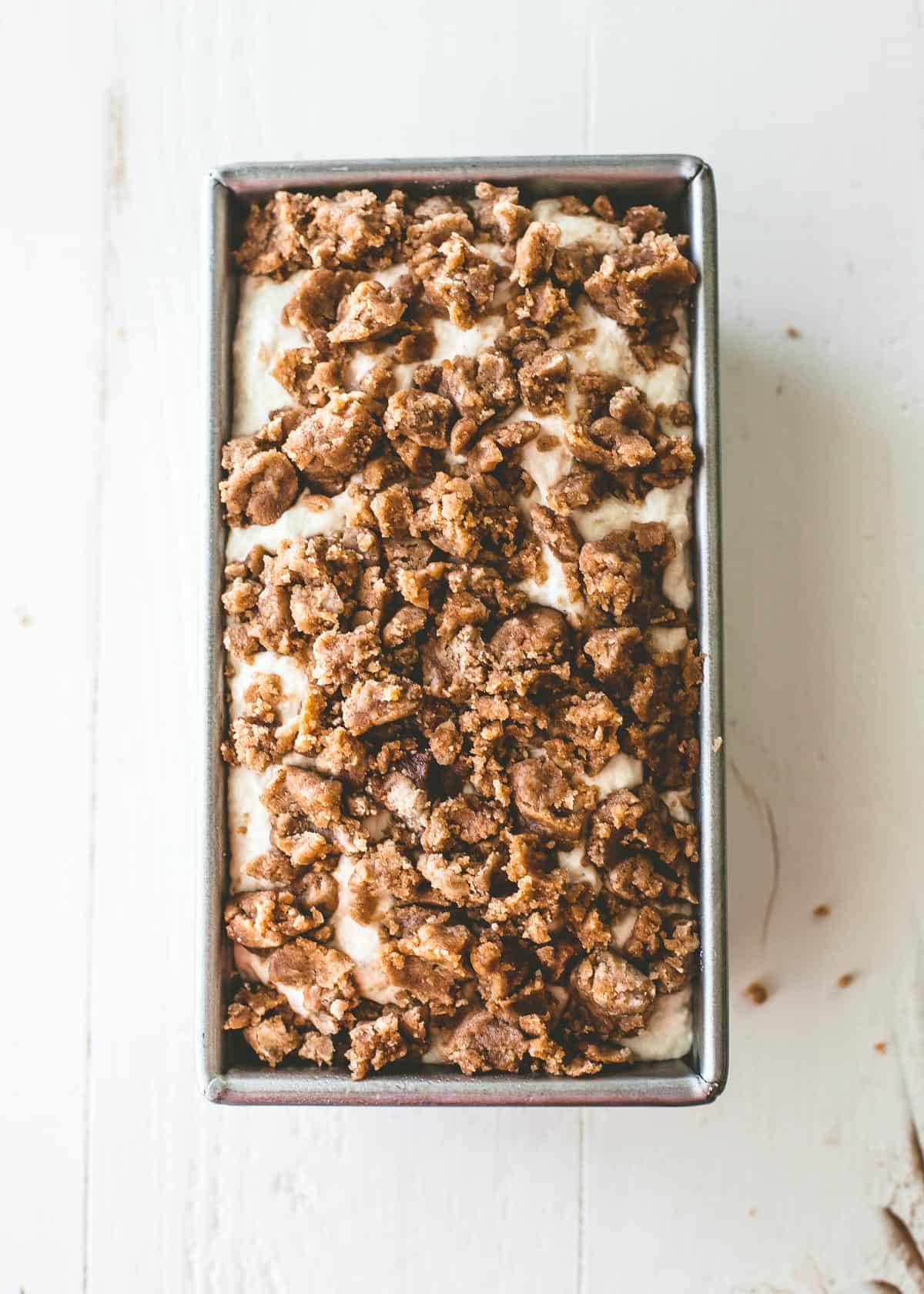 raw dough topped with streusel in a loaf pan