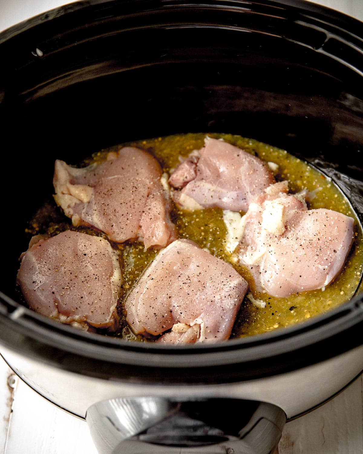 chicken and salsa verde in a slow cooker