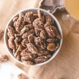 sweet and spicy candied pecans in a white bowl