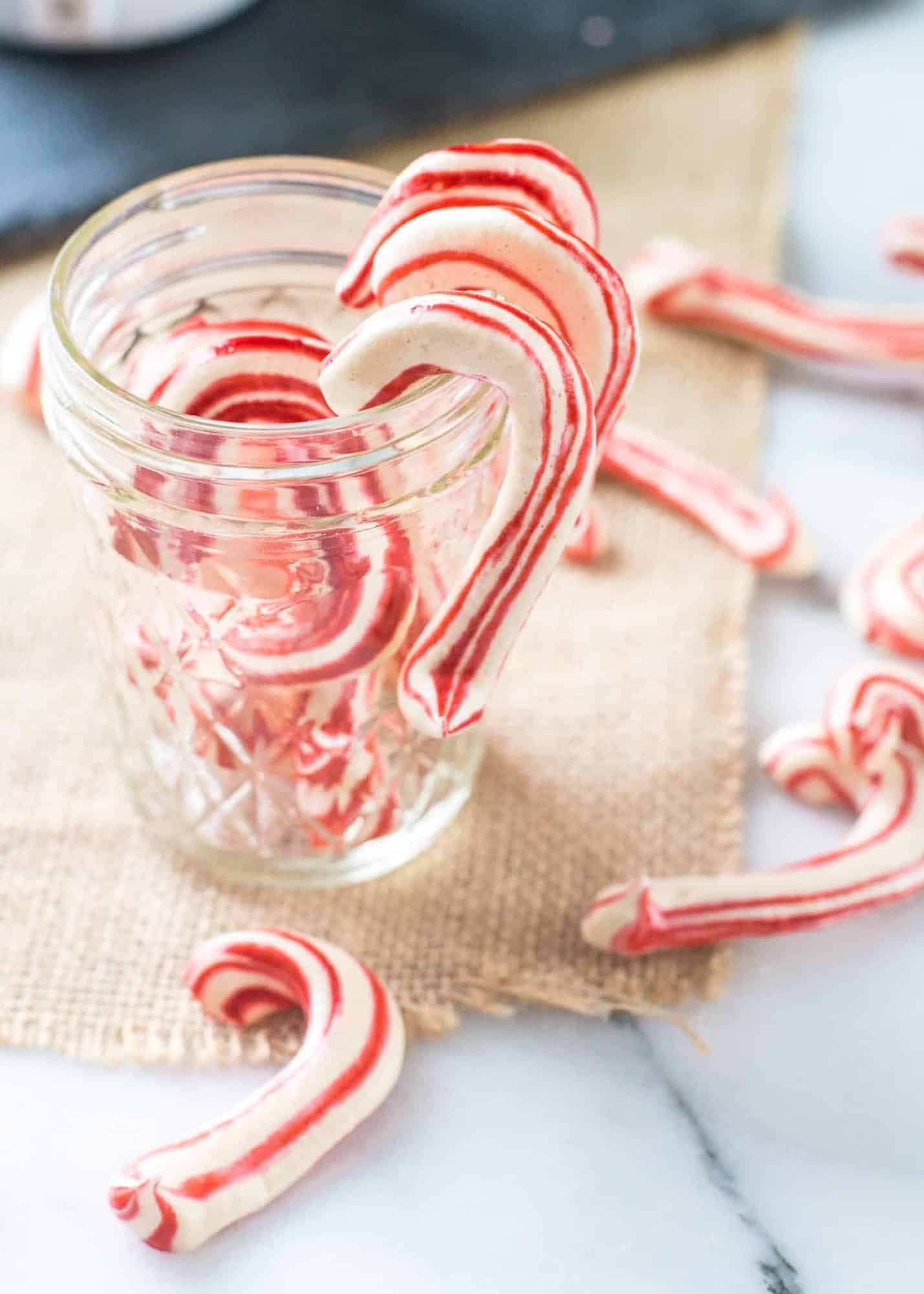 candy cane shaped meringues on a glass jar