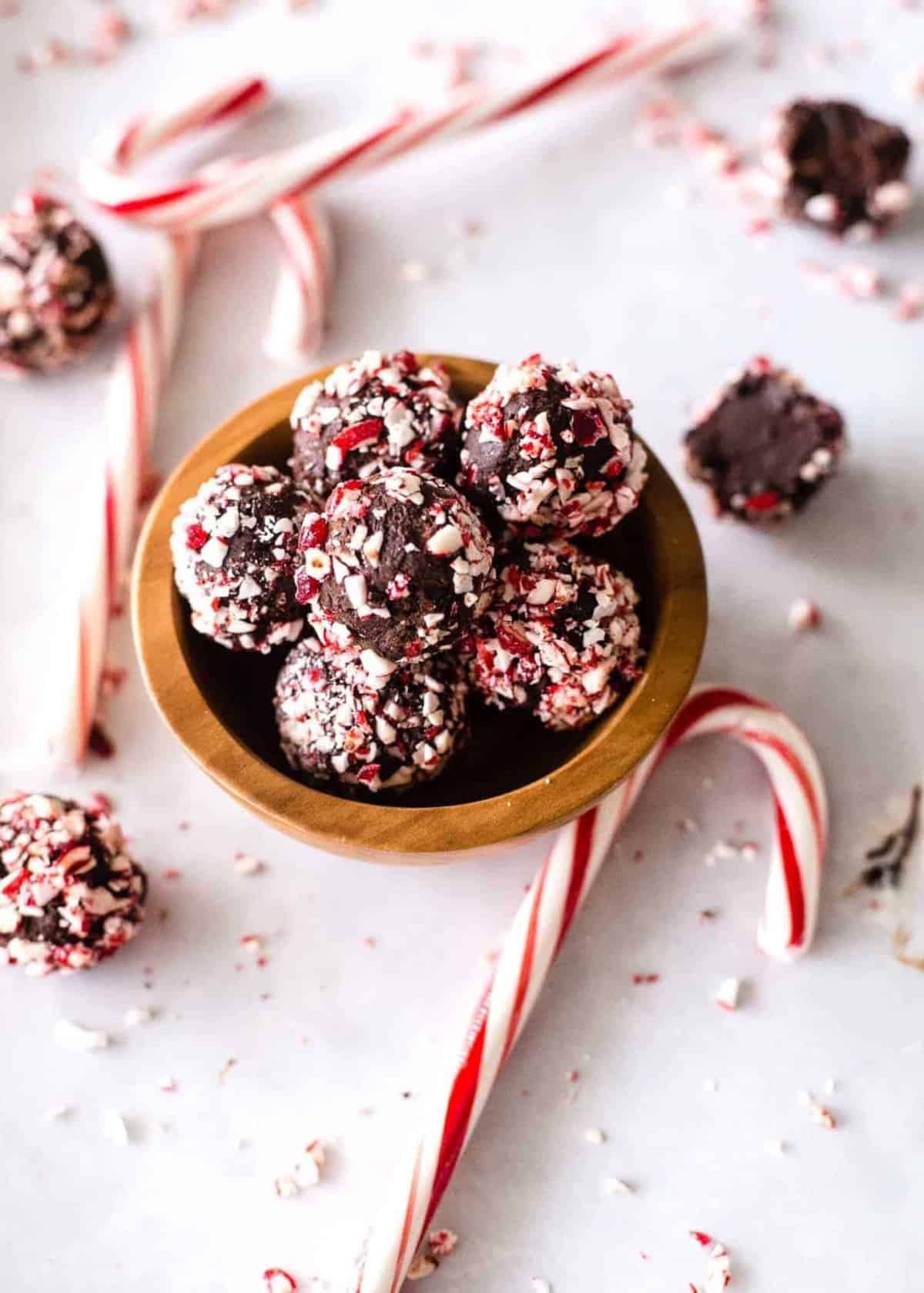 chocolate candy cane truffles in a wooden bowl