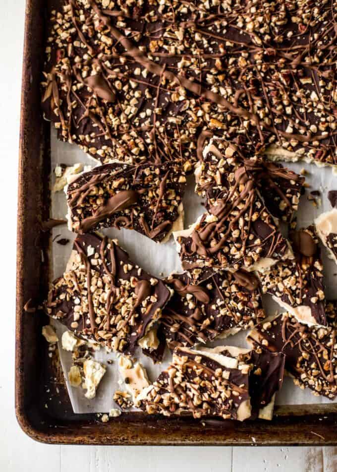 saltine toffee bark pieces on a sheet pan