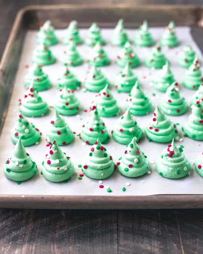 christmas tree meringues on a parchment lined sheet pan