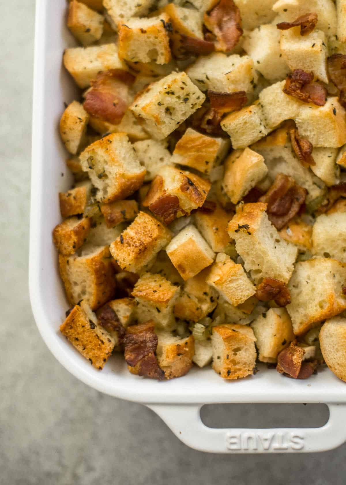 cooked stuffing in a white baking dish