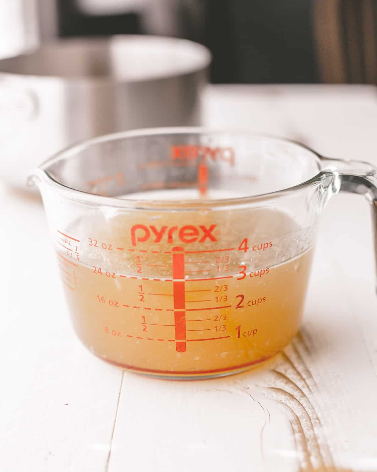 turkey stock in a clear measuring cup