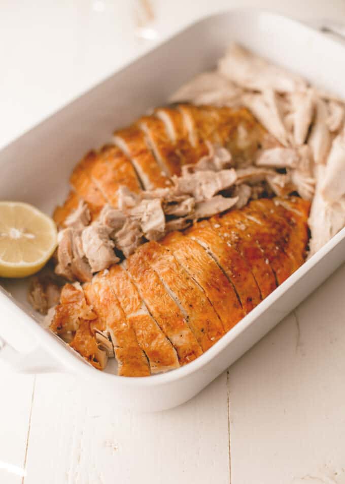 sliced roasted turkey in a baking dish