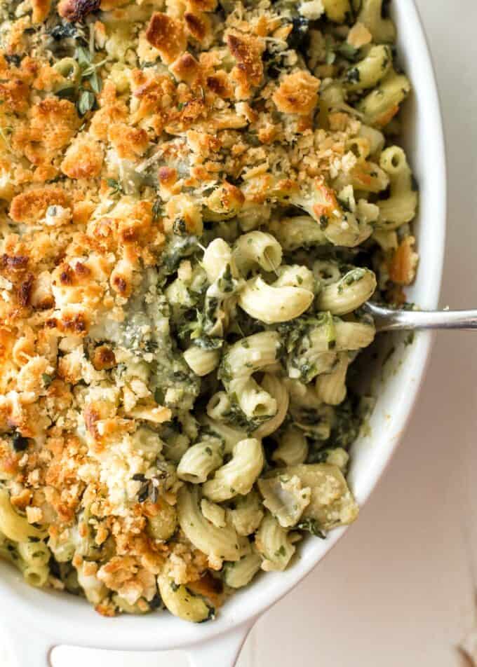 spinach and artichoke baked pasta in a white baking dish