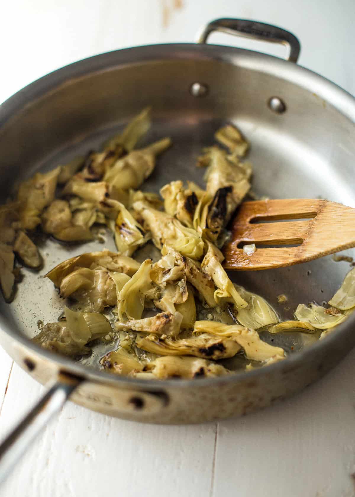 cooking artichoke hearts in a skillet