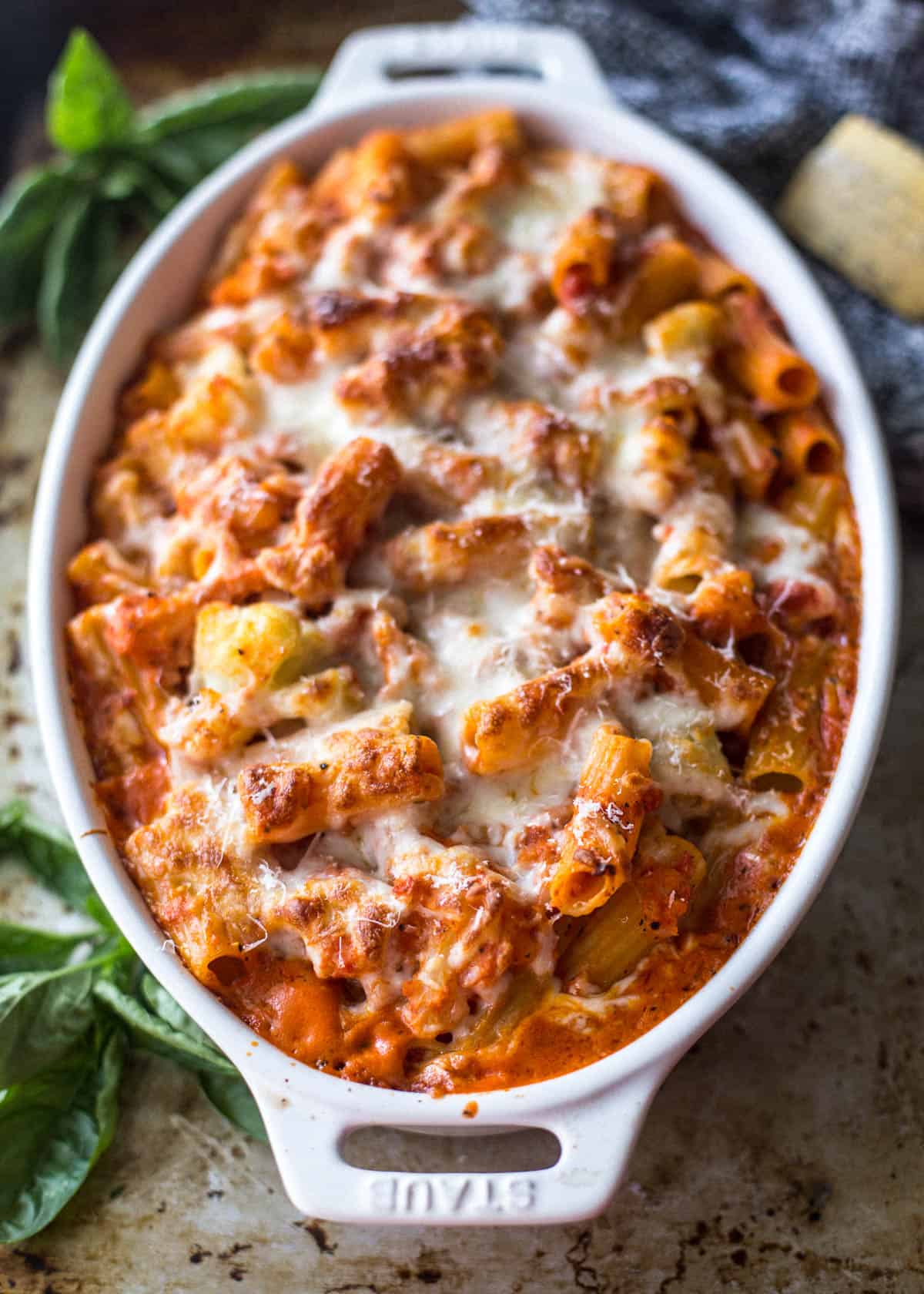 baked ziti in a white oval baking dish