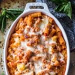 cauliflower baked ziti in a white oval baking dish