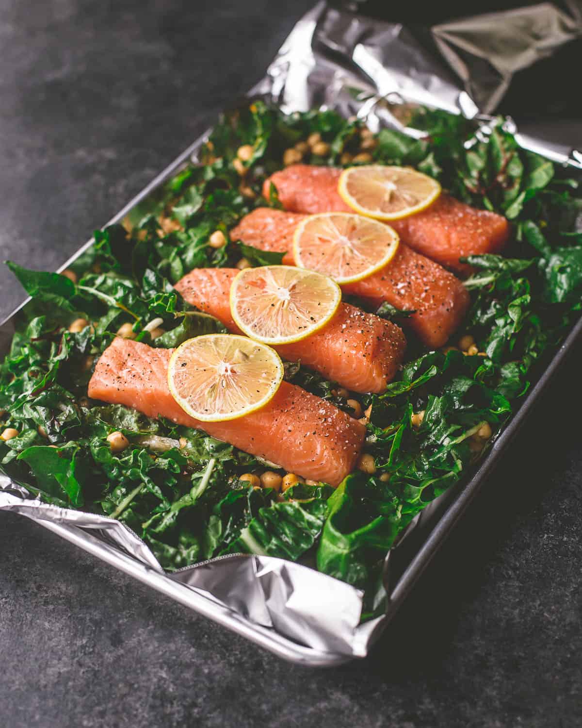 salmon filets on a bed of greens and chickpeas 