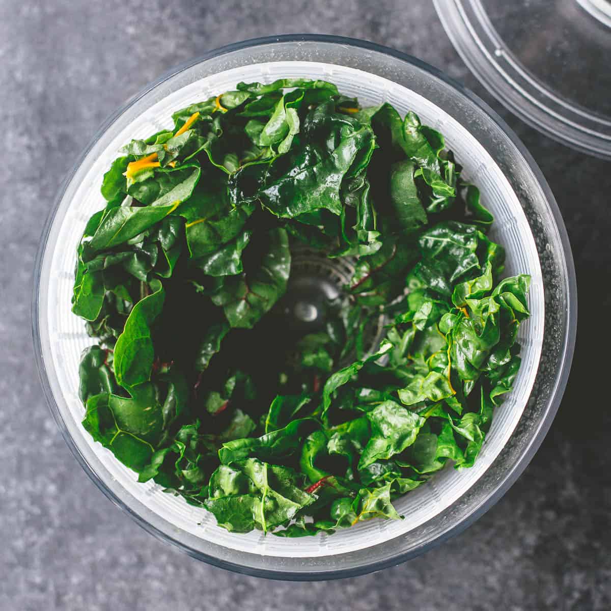 mixed greens in a salad spinner