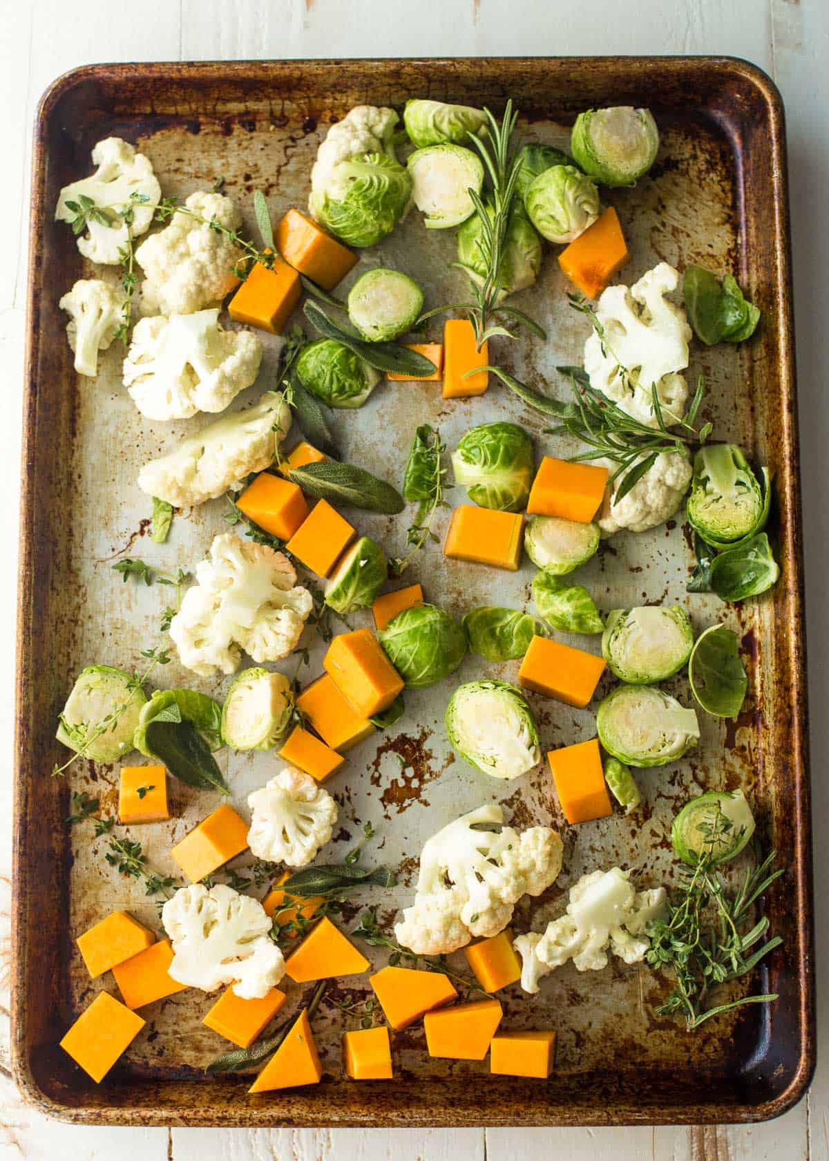 overhead image of raw vegetables on a sheet pan