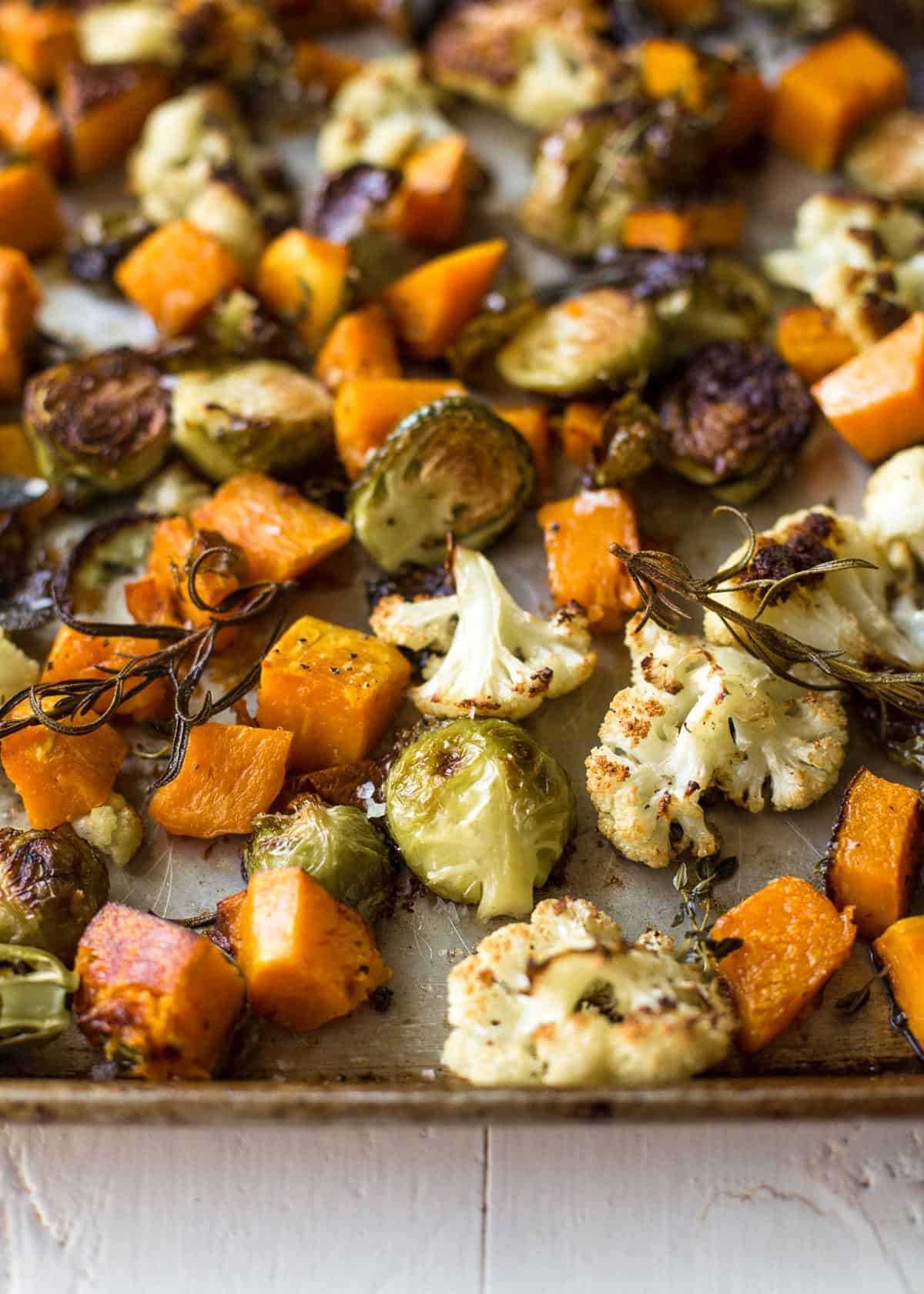 herb roasted vegetables on a sheet pan