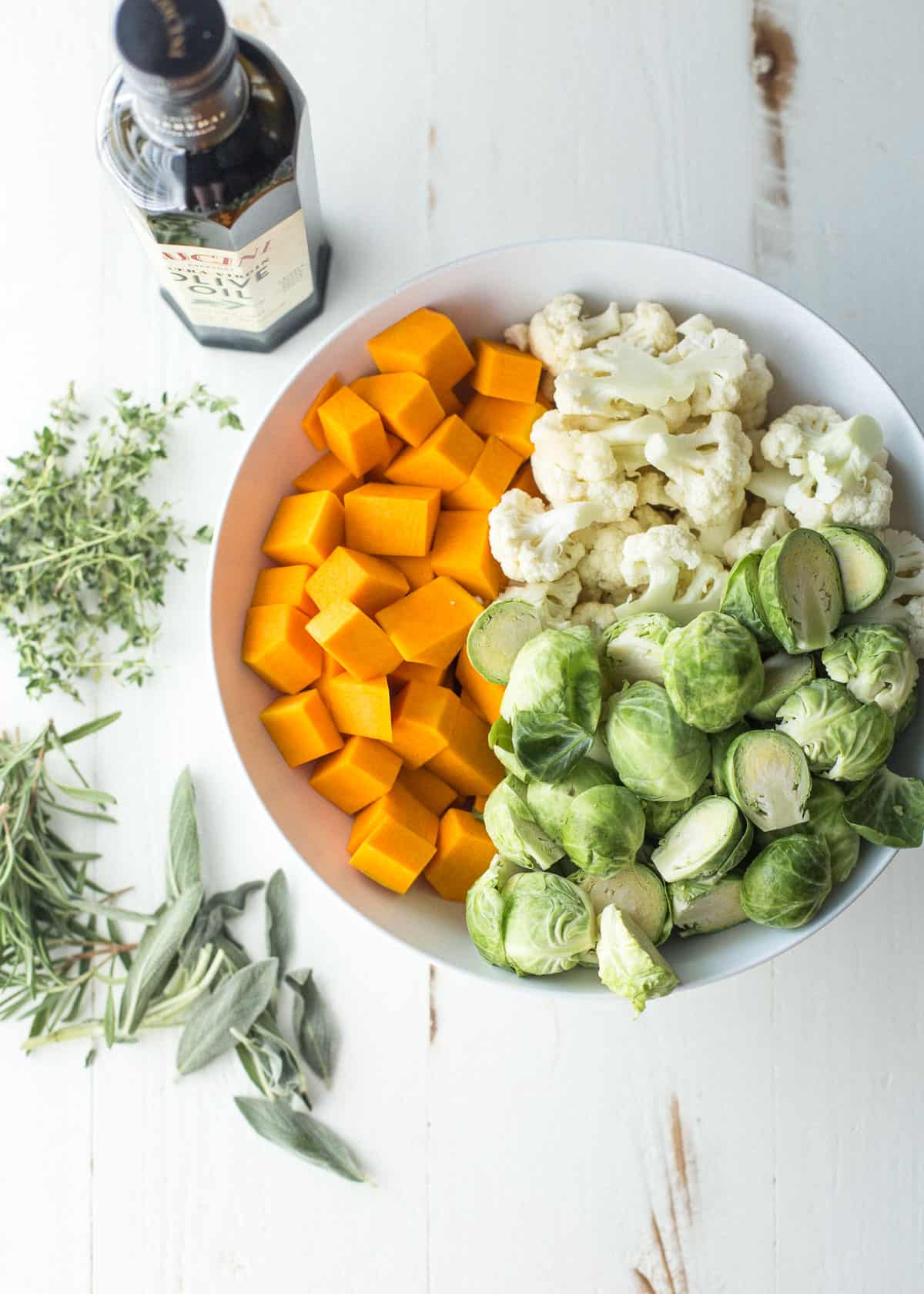 overhead image of raw vegetables in a white bowl