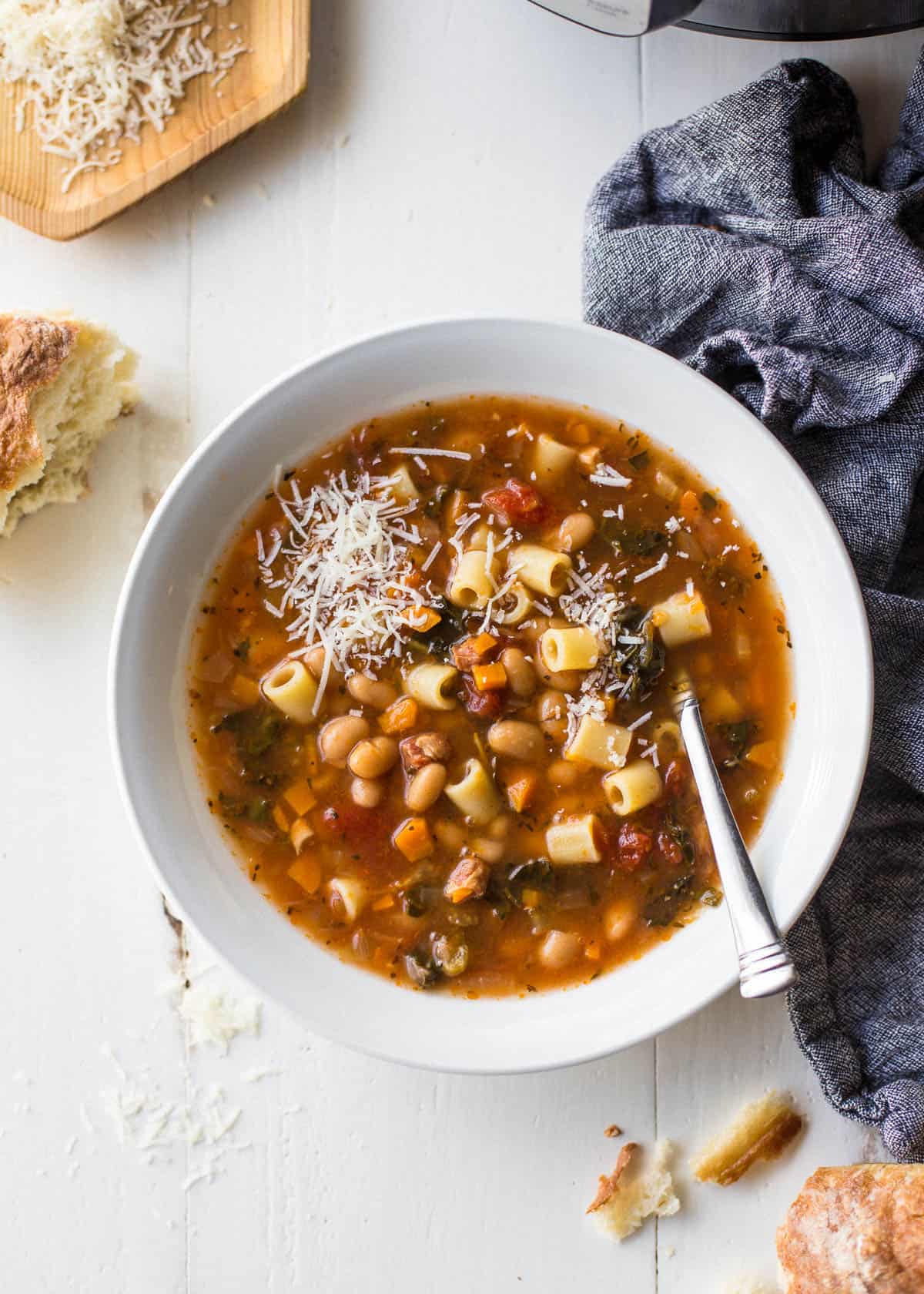 instant pot pasta e fagioli soup in a white bowl with a spoon