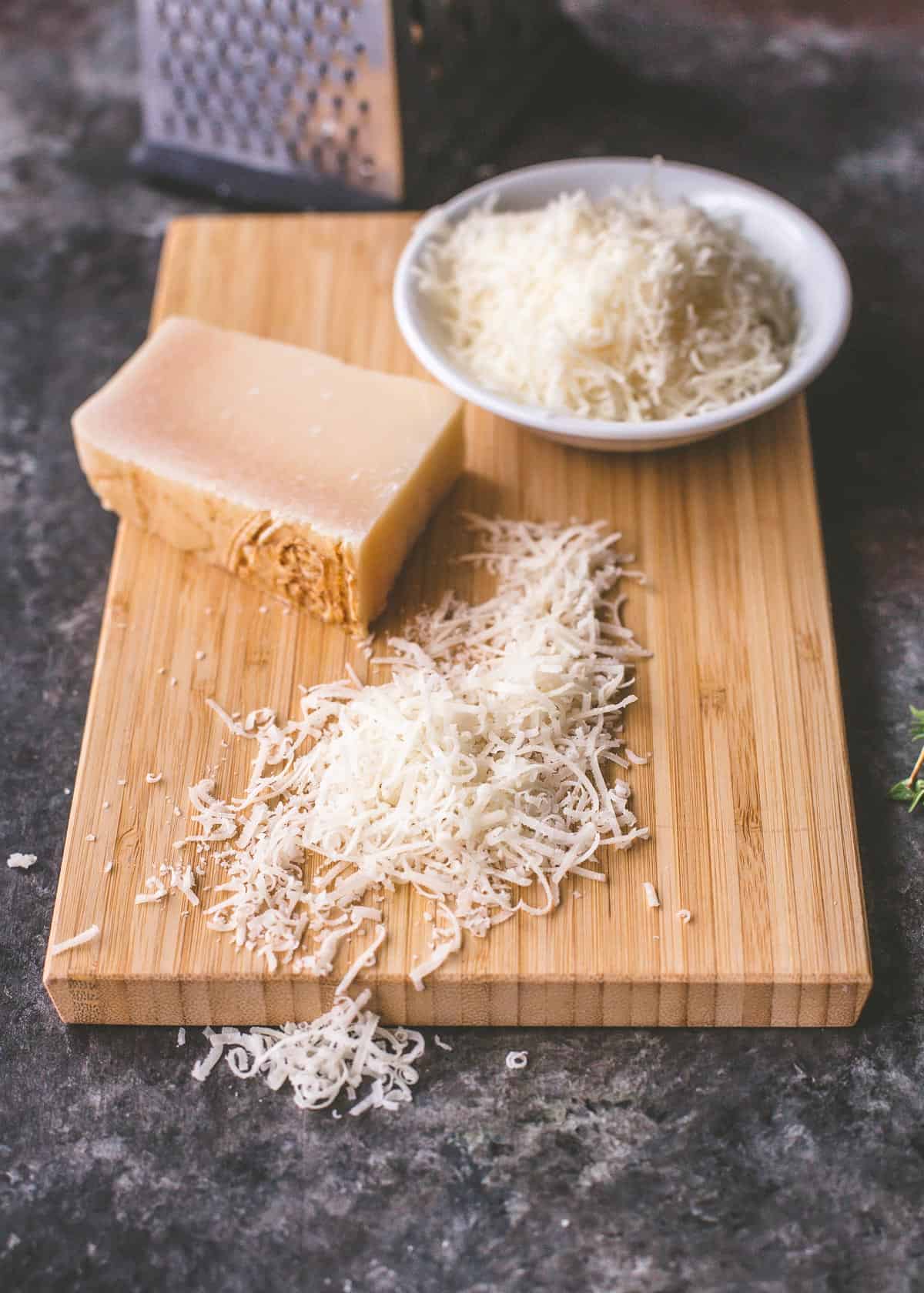 grated parmesan on a wooden cutting board