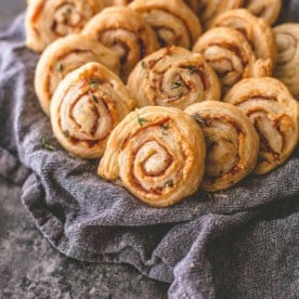 cheese pinwheels in a towel lined basket