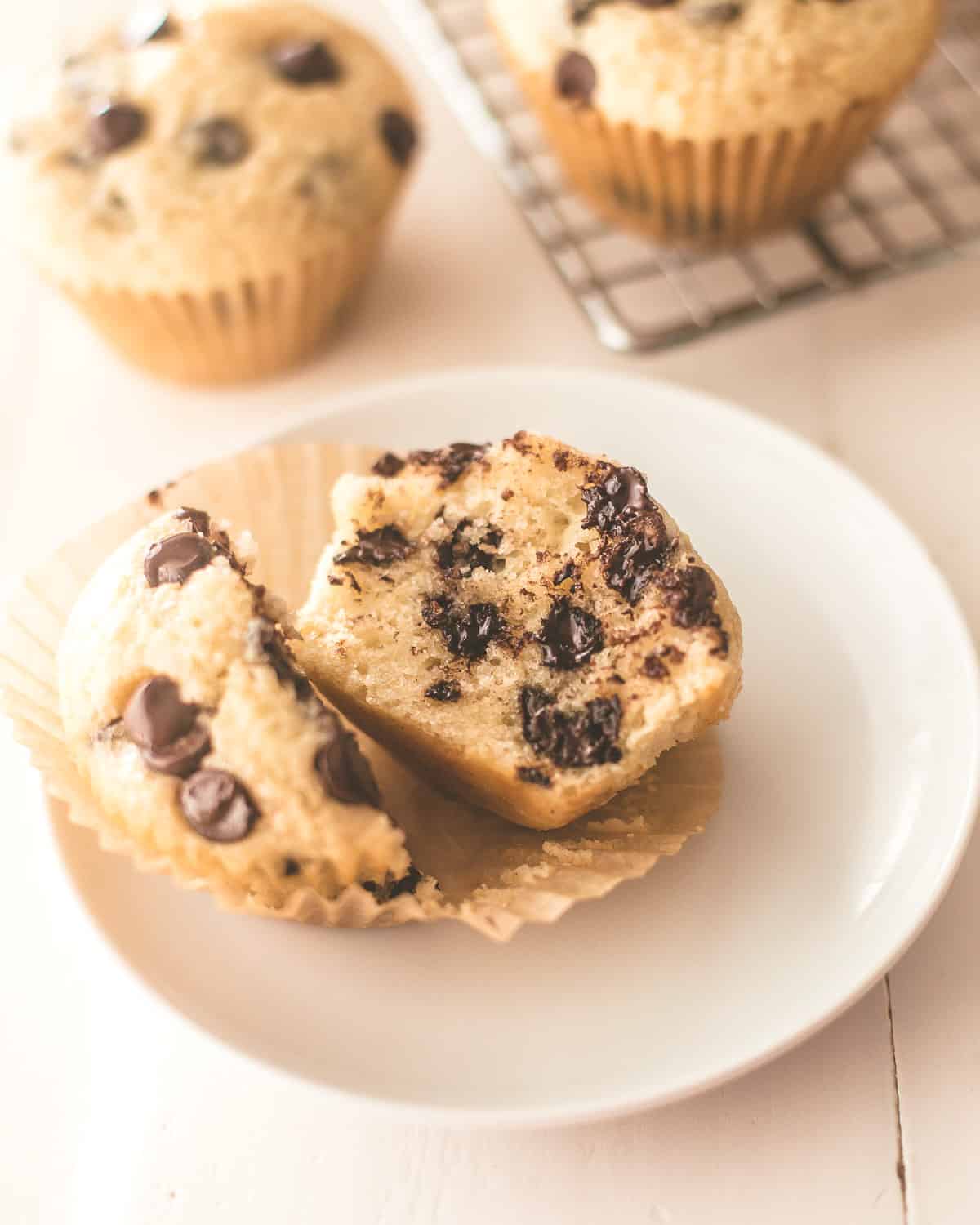 a muffin cut in half on a white plate