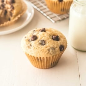 a chocolate chip muffin on a white table