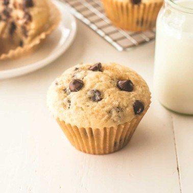 a chocolate chip muffin on a white table
