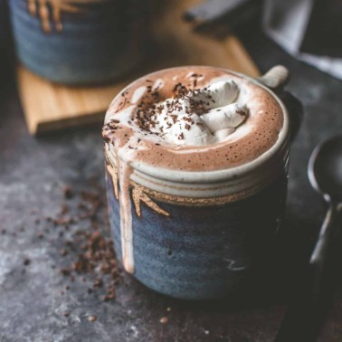 hot chocolate topped with whipped cream in a blue mug