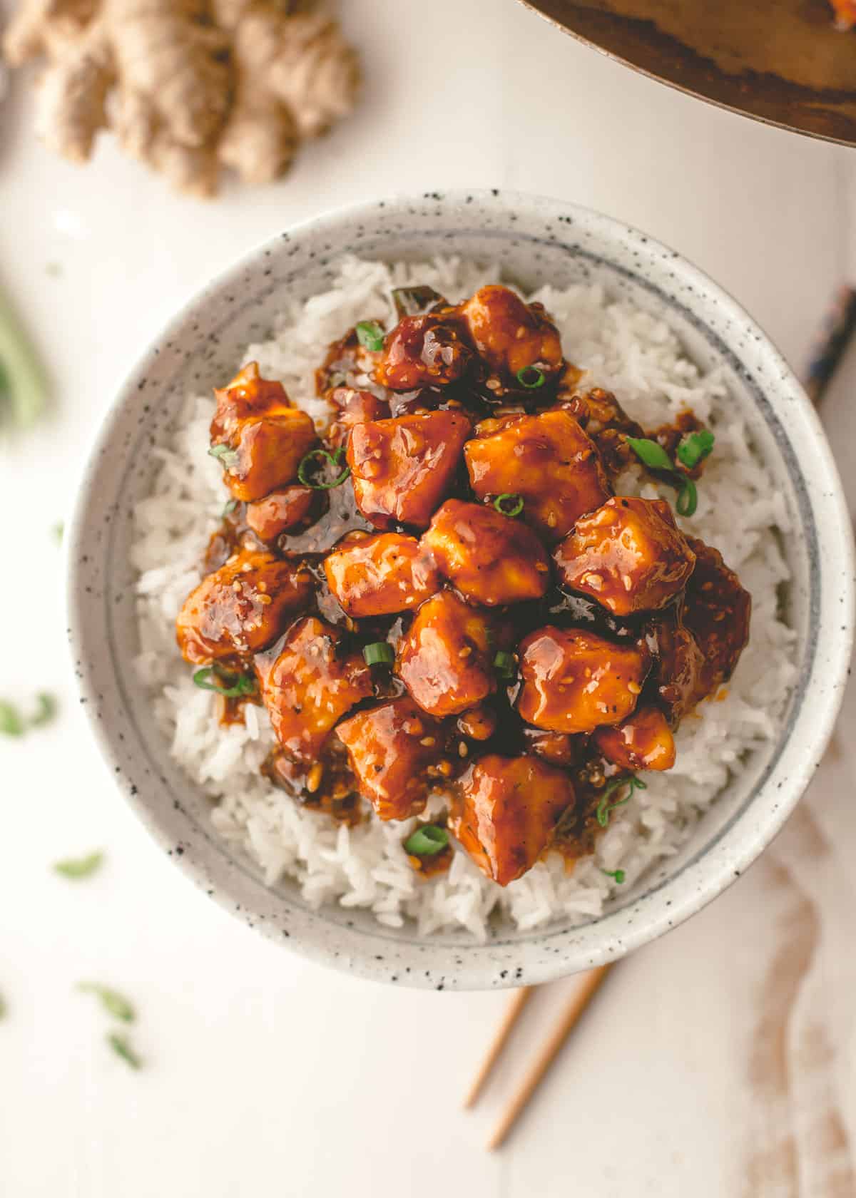 stir fry over rice in a white bowl