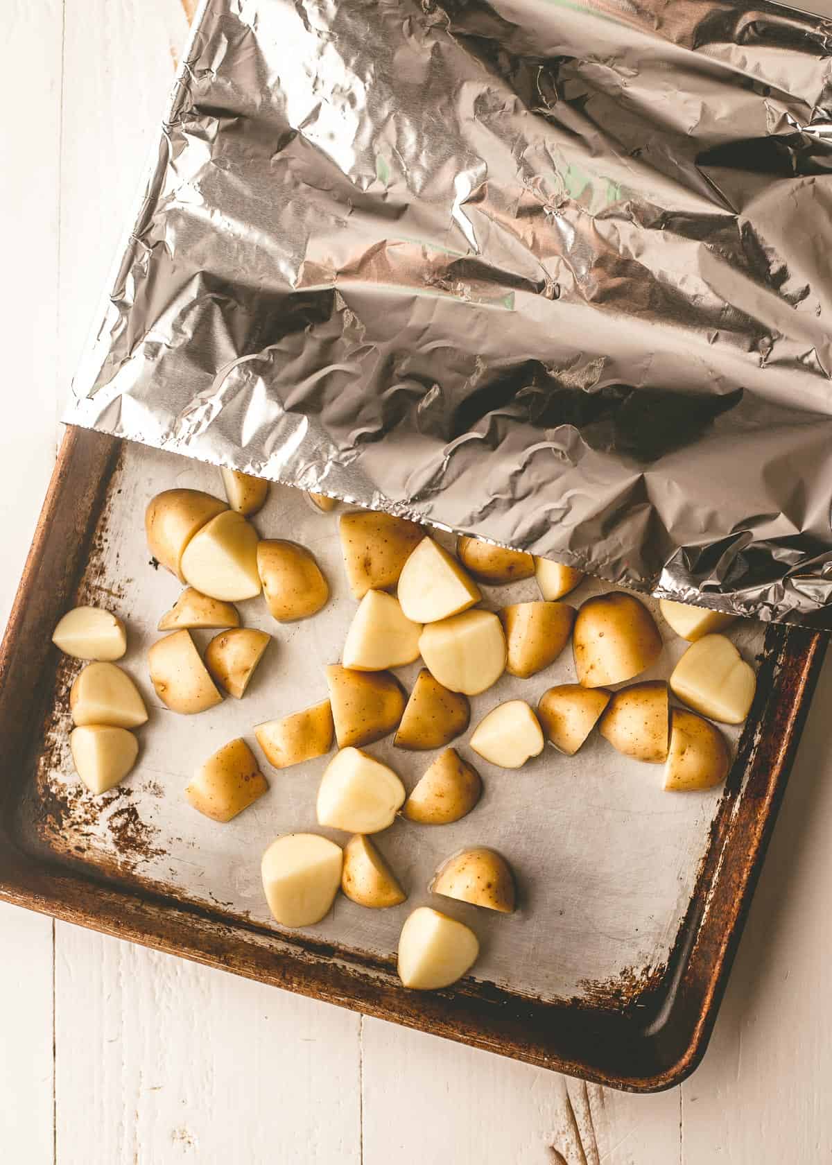 diced potatoes on a sheet pan covered in foil
