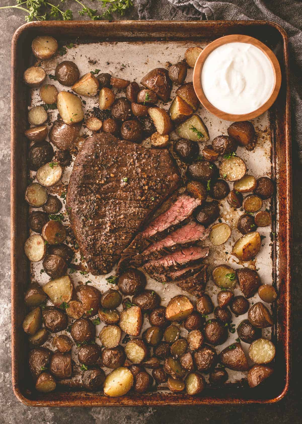 steak and potatoes on a sheet pan