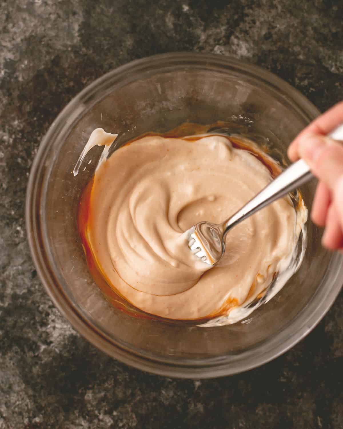 making sauce for smash burgers in a glass mixing bowl