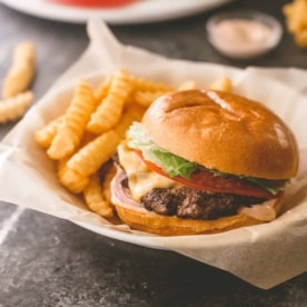 burger and fries in a paper lined basket