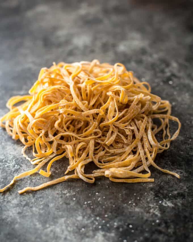 a nest of chiang mai noodles on a grey countertop