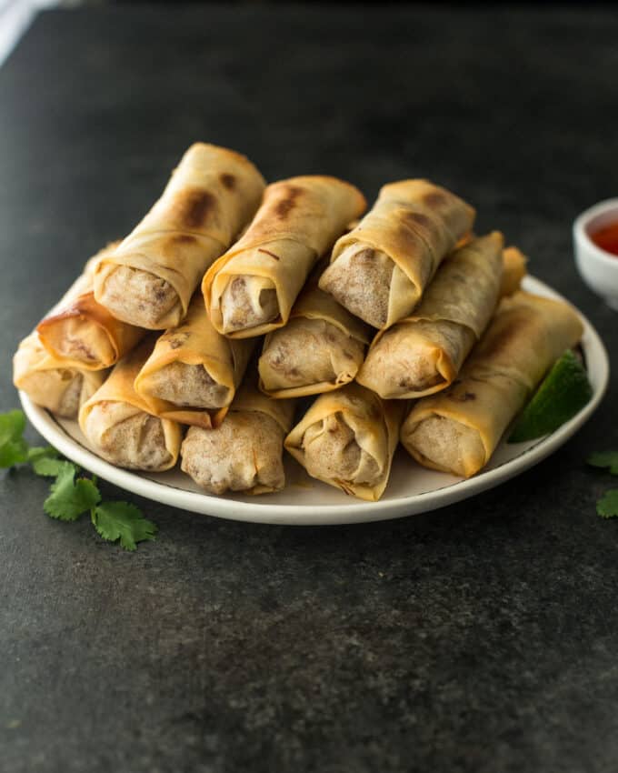 spring rolls stacked on a white plate