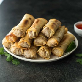 spring rolls stacked on a white plate