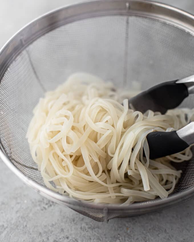 cooked rice noodles in colander