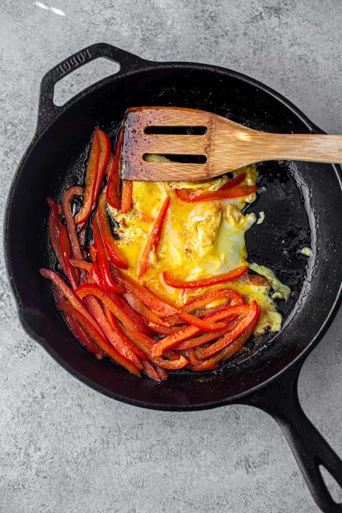 bell peppers and scrambled eggs in cast iron skillet
