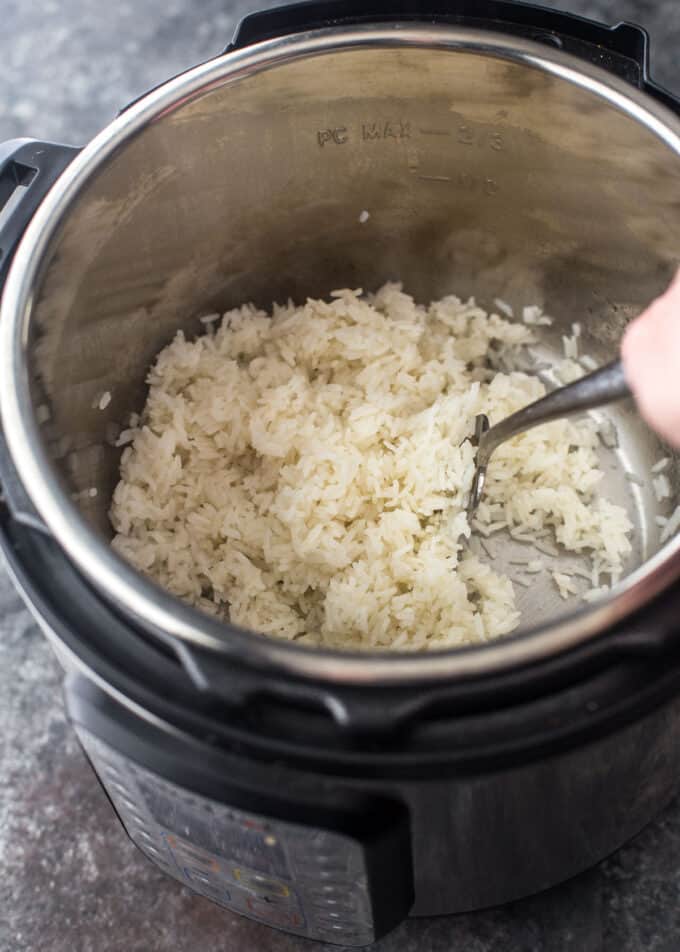 fluffing rice with a fork in an instant pot