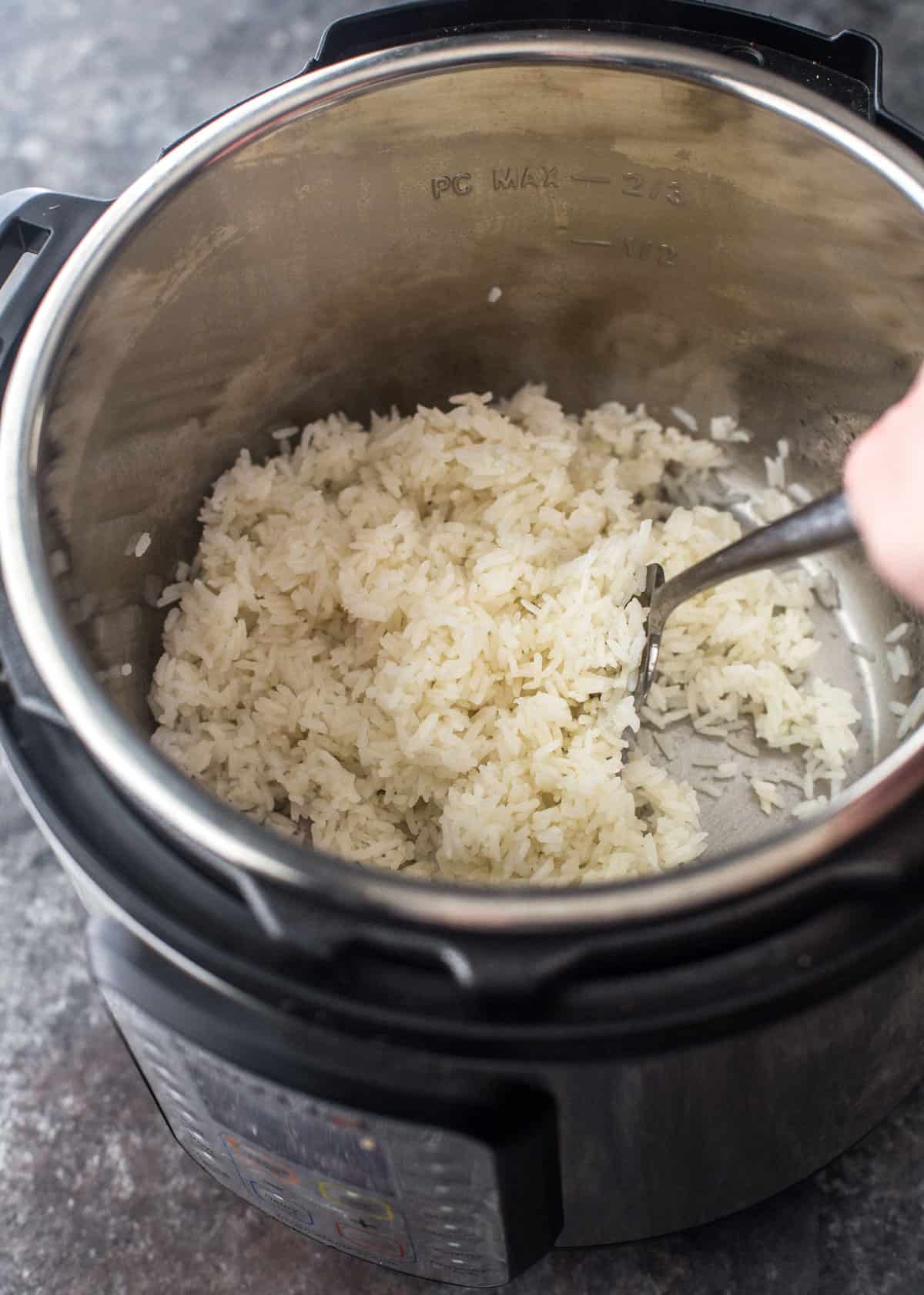 fluffing rice with a fork
