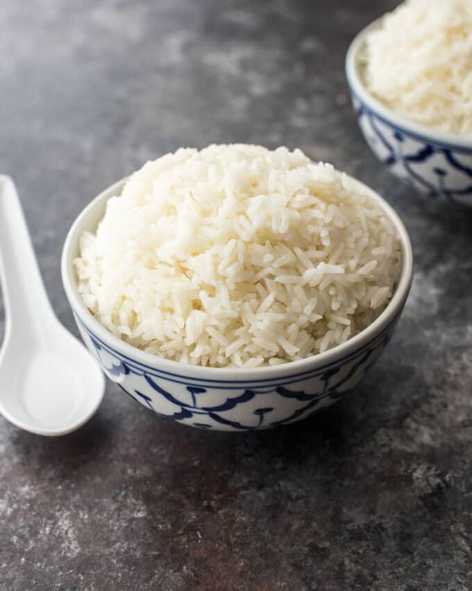 a bowl of jasmine rice on a grey countertop