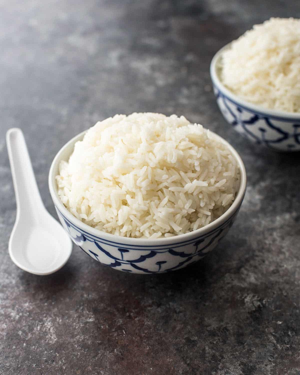 a bowl of jasmine rice on a grey countertop